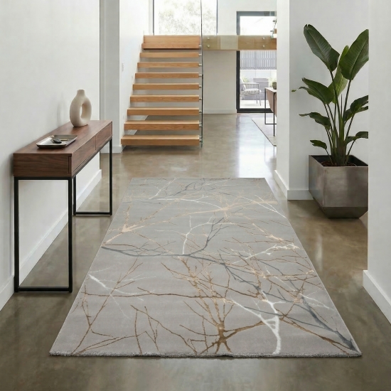 Designer Teppich mit abstraktem glänzenden Ästemuster gold