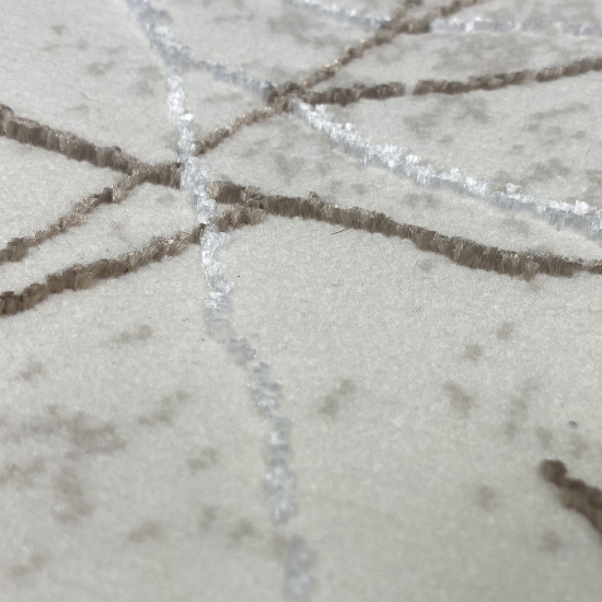 Designer Teppich mit abstraktem glänzenden Ästemuster creme