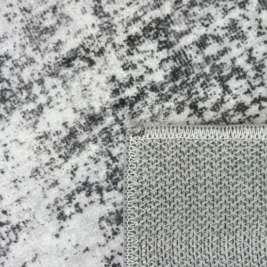 Grauer Teppich mit Vintage-Medaillon und ruhiger Musterwirkung