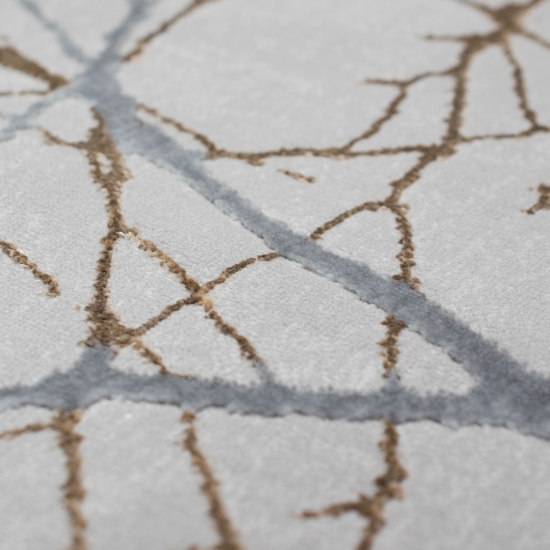 Designer Teppich mit abstraktem glänzenden Ästemuster gold