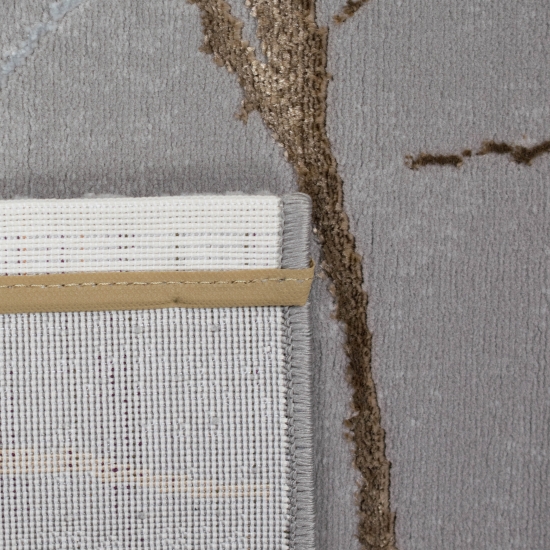 Designer Teppich mit abstraktem Ästemuster in gold