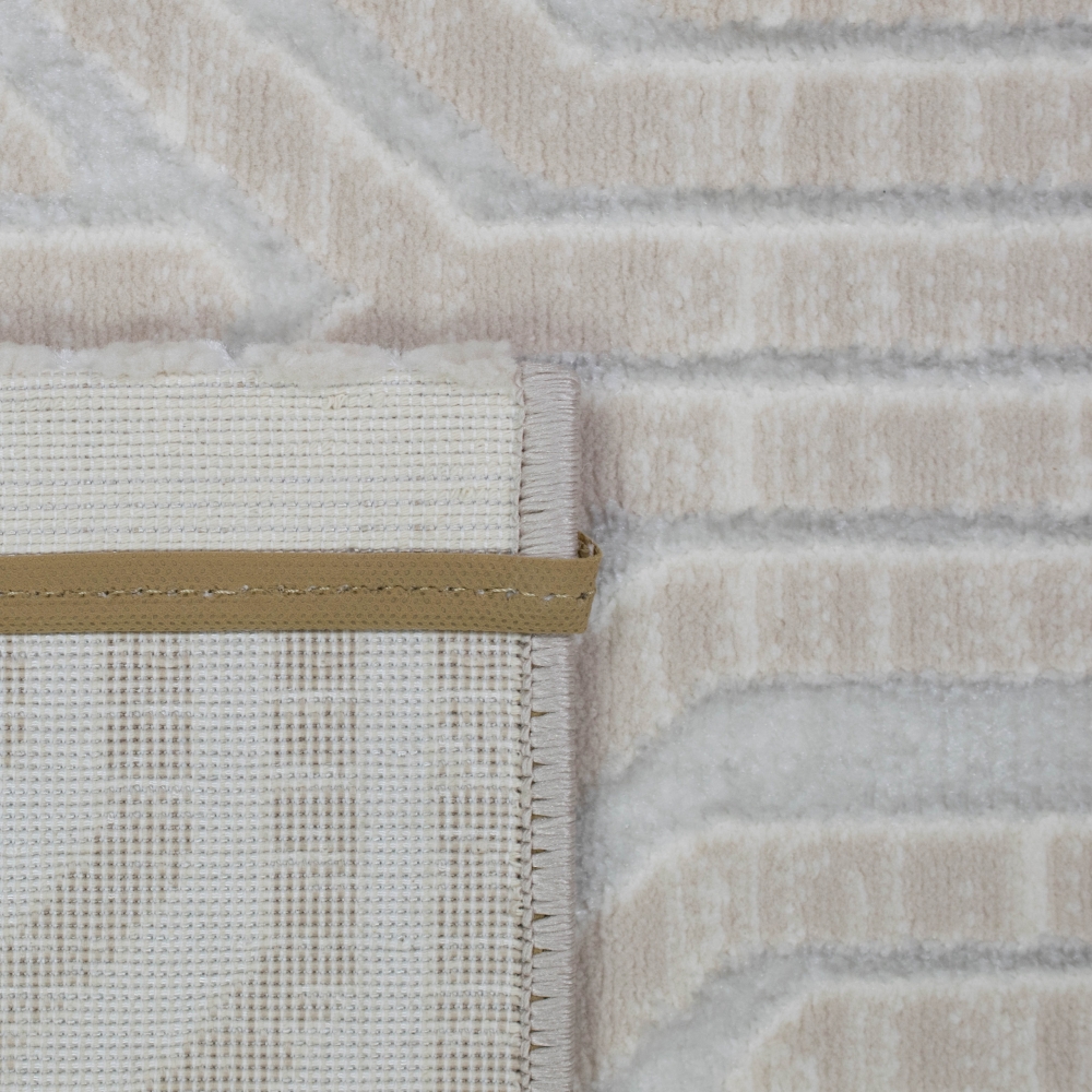 Schlichter Designerteppich dezent gemustert in creme